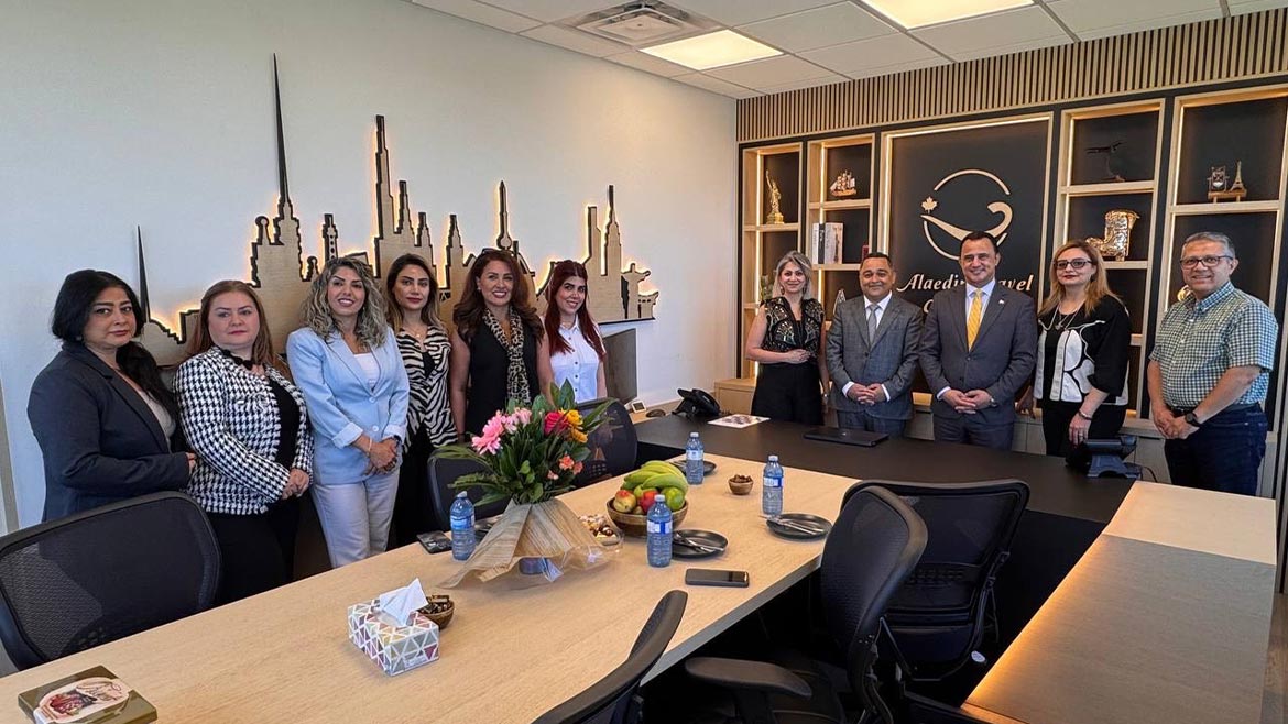 Michael Parsa presenting a commemorative recognition to Alaedin Travel Canada during its 2026 anniversary.
