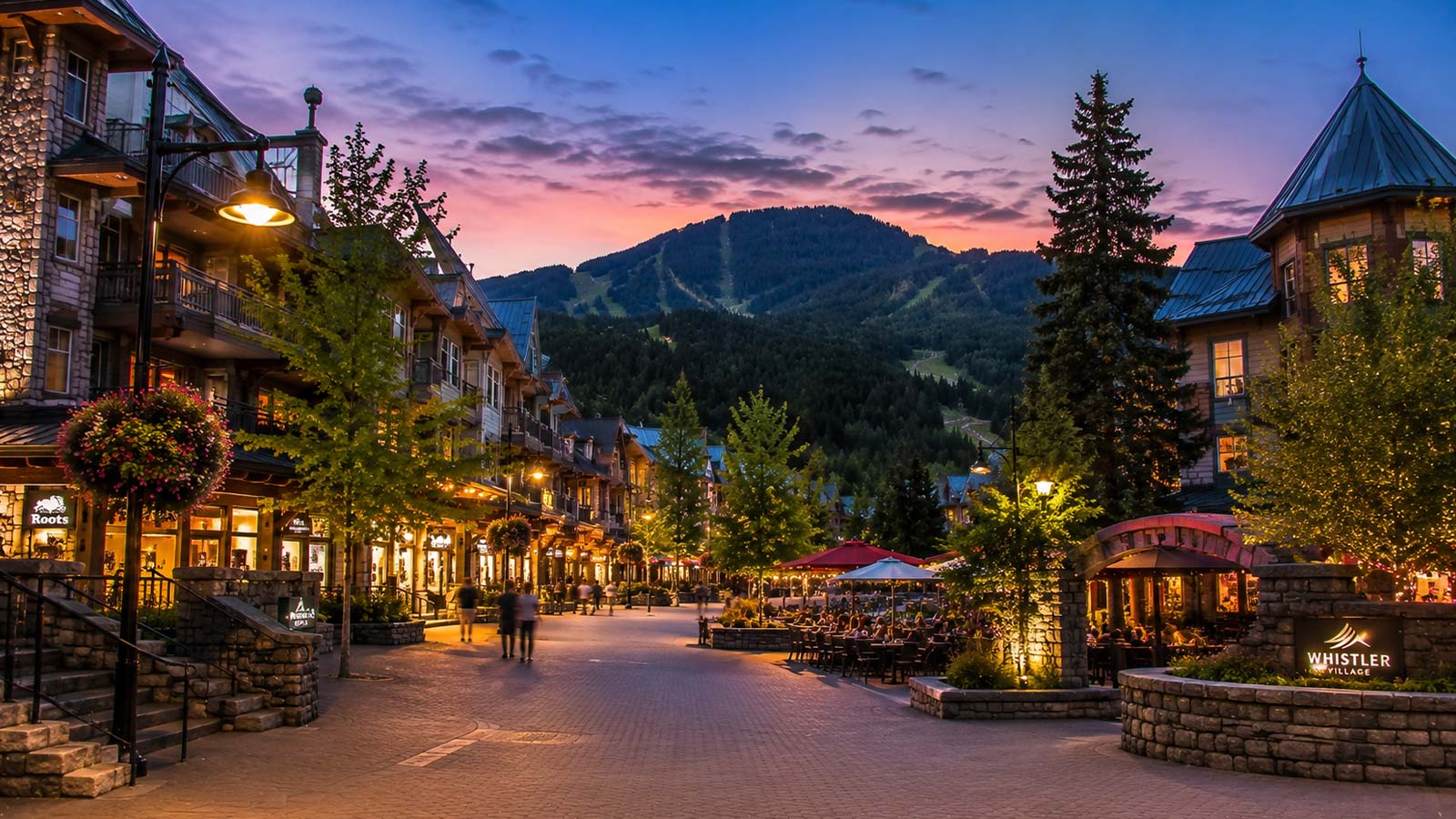 Whistler Village pedestrian street with mountain views at sunset